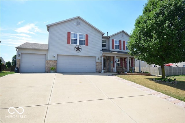 front facade featuring a garage, a front yard, and covered porch