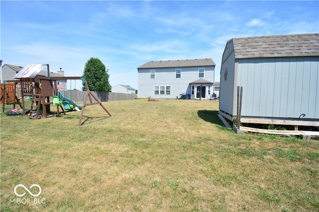 view of yard featuring a storage shed and a playground