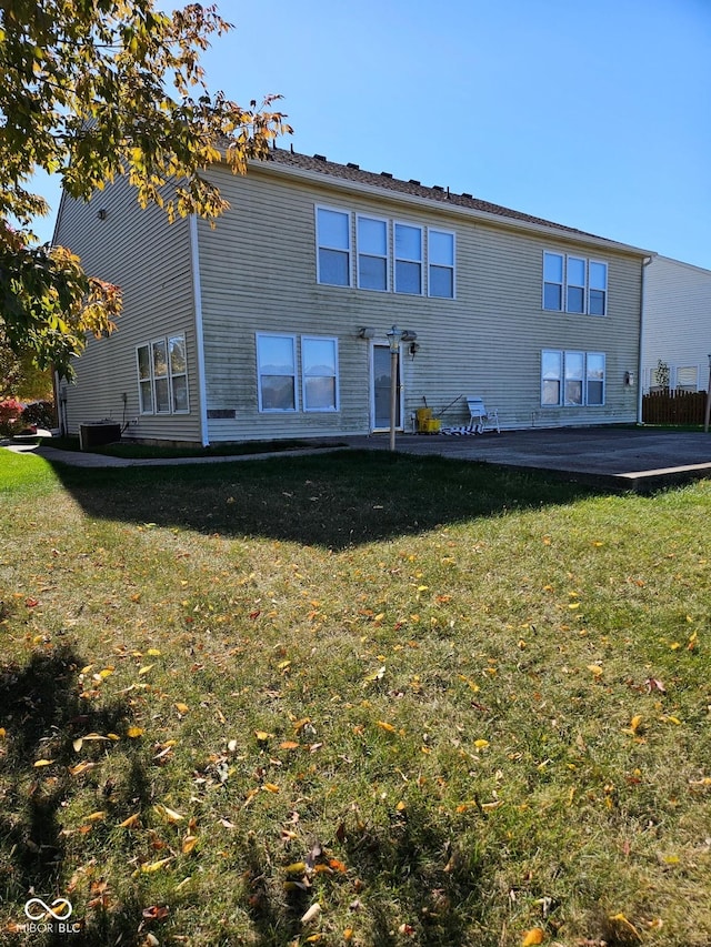 rear view of property with a lawn and a patio area