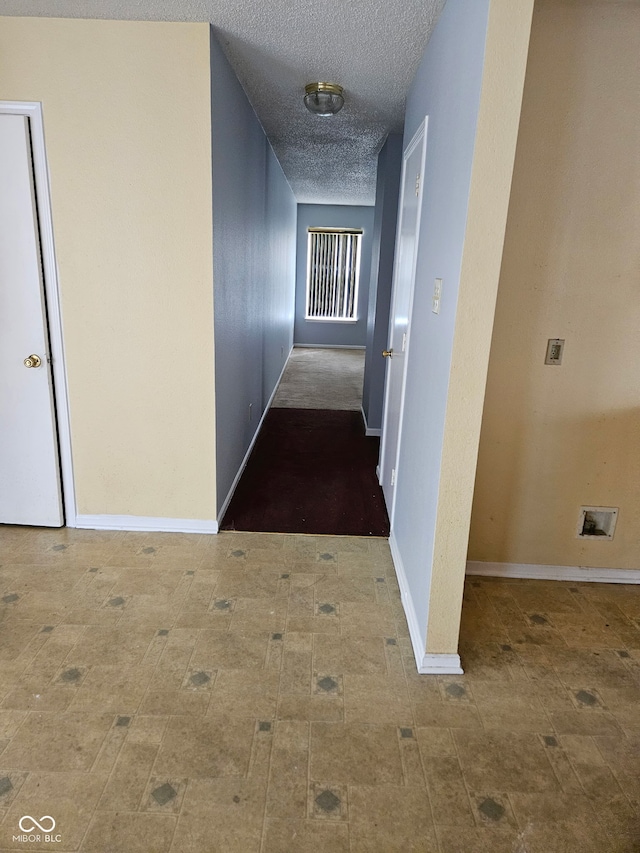 hallway featuring a textured ceiling