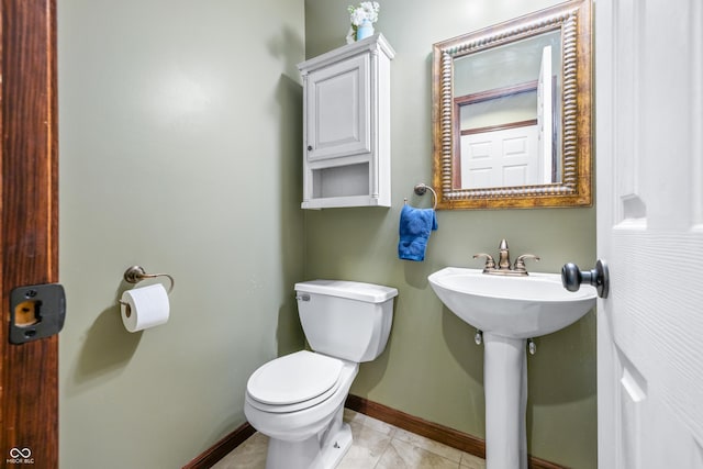 bathroom with tile patterned flooring, sink, and toilet