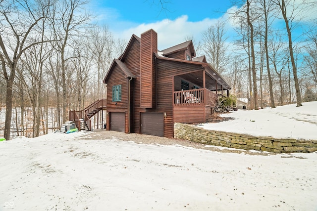 snow covered property featuring a garage