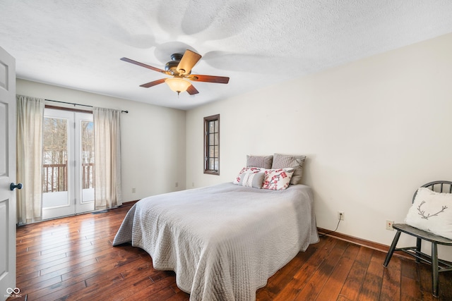 bedroom featuring ceiling fan, access to exterior, dark hardwood / wood-style flooring, and a textured ceiling