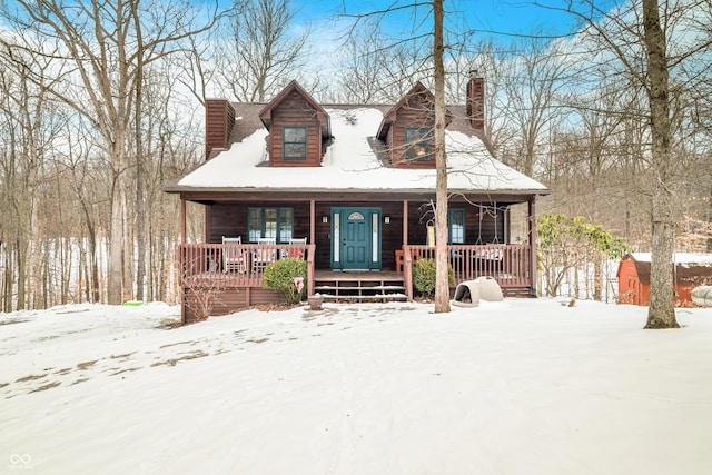 view of front facade featuring covered porch and a storage shed