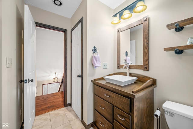 bathroom featuring tile patterned flooring, vanity, and toilet