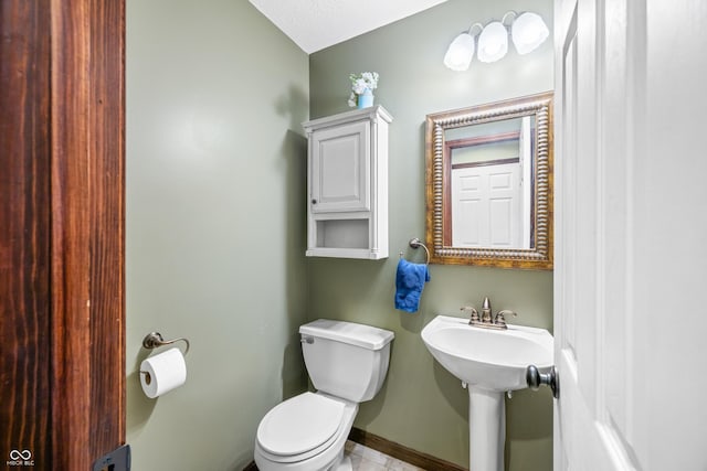 bathroom featuring sink, a textured ceiling, and toilet