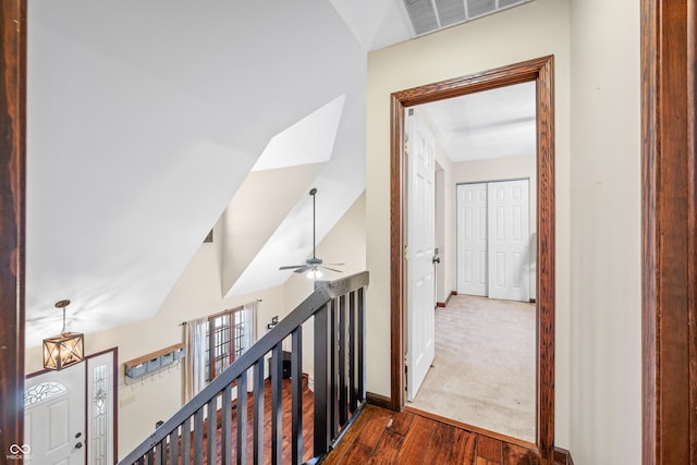 corridor featuring vaulted ceiling and dark hardwood / wood-style floors