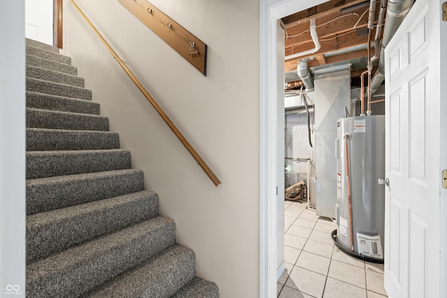 stairway with tile patterned flooring and water heater