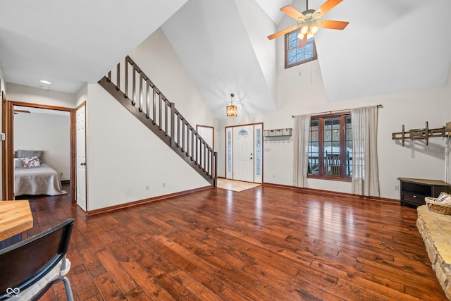 living room with hardwood / wood-style flooring, high vaulted ceiling, and ceiling fan