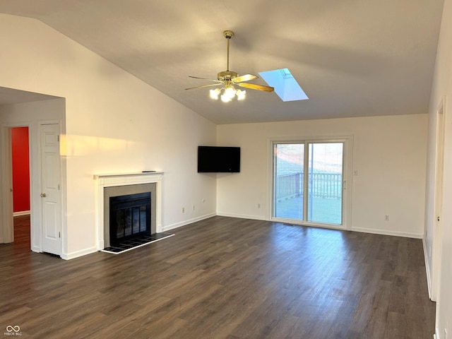 unfurnished living room featuring dark hardwood / wood-style floors, vaulted ceiling with skylight, and ceiling fan