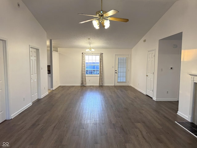 interior space featuring dark hardwood / wood-style floors, ceiling fan with notable chandelier, and high vaulted ceiling