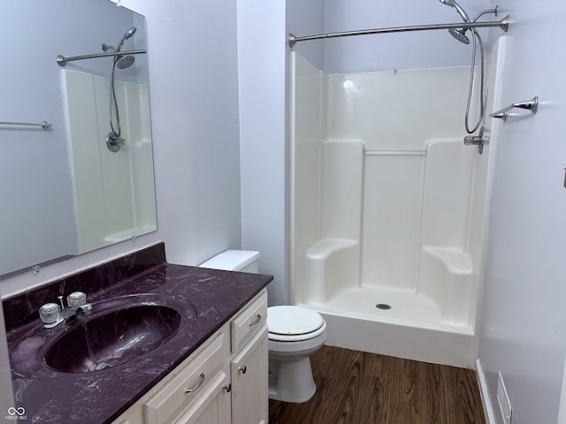 bathroom with walk in shower, vanity, toilet, and hardwood / wood-style flooring