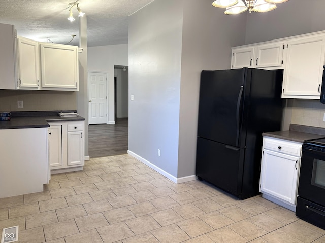 kitchen featuring black appliances, vaulted ceiling, decorative backsplash, and white cabinets