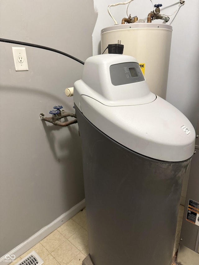 interior space featuring tile patterned flooring and water heater