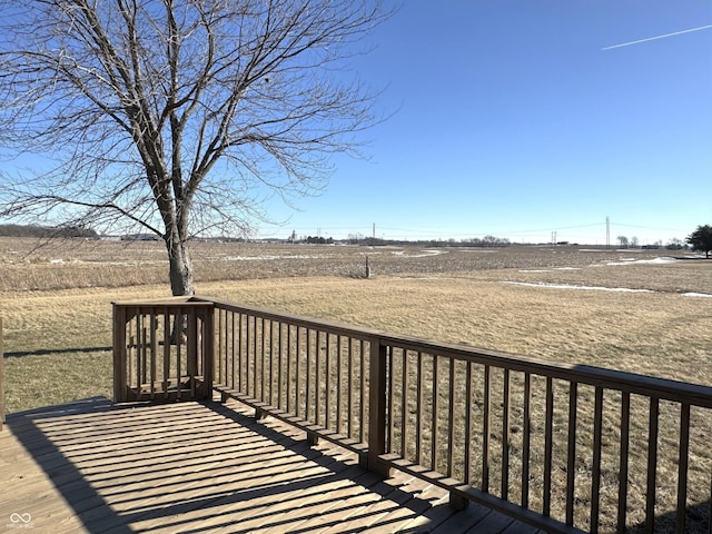 wooden deck with a rural view