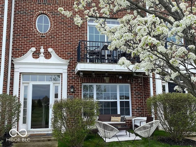 rear view of property featuring a balcony