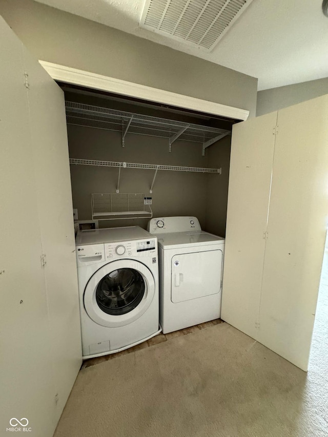 laundry area with washing machine and clothes dryer