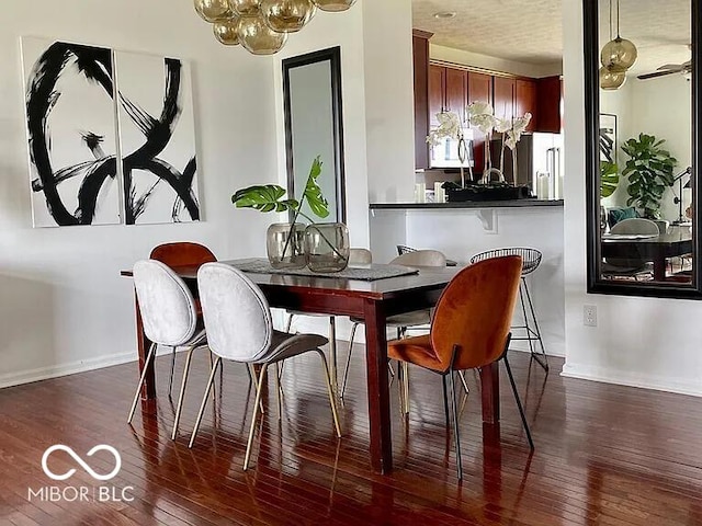 dining space featuring ceiling fan and dark hardwood / wood-style flooring