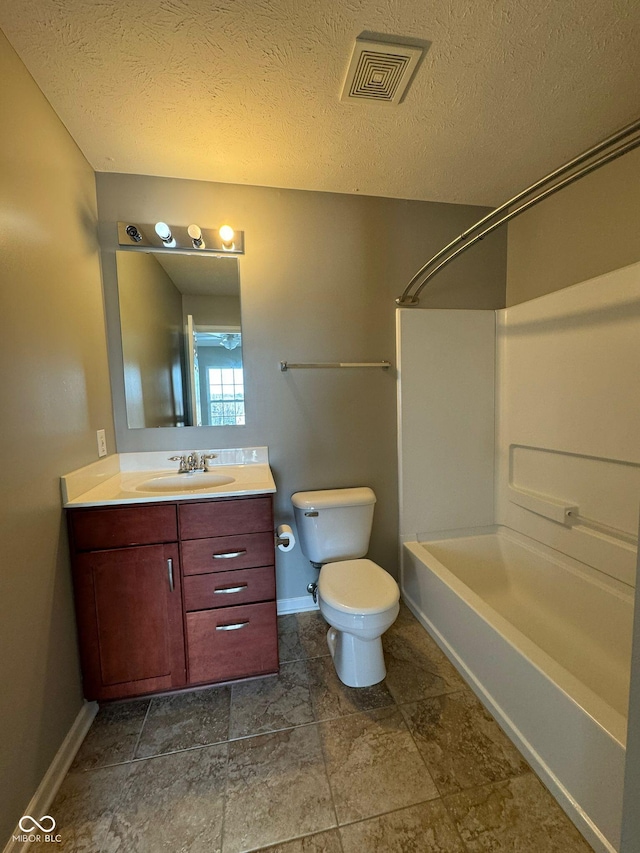 full bathroom featuring vanity, toilet, shower / bath combination, and a textured ceiling