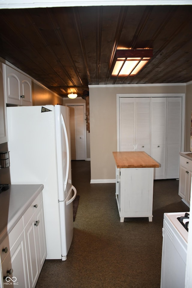 kitchen with white cabinetry, white appliances, butcher block counters, and wooden ceiling