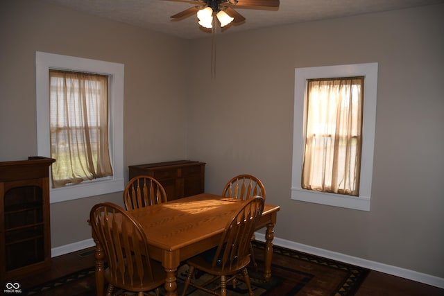 dining room with dark wood-type flooring, a textured ceiling, and ceiling fan