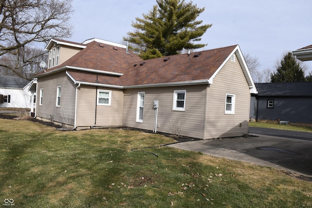 rear view of property featuring a yard