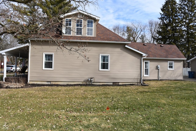 rear view of property with a lawn