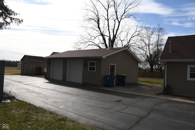 exterior space featuring a garage and an outdoor structure