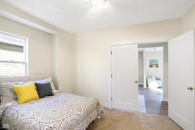 carpeted bedroom with a textured ceiling