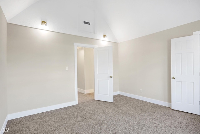 unfurnished room featuring lofted ceiling and carpet flooring