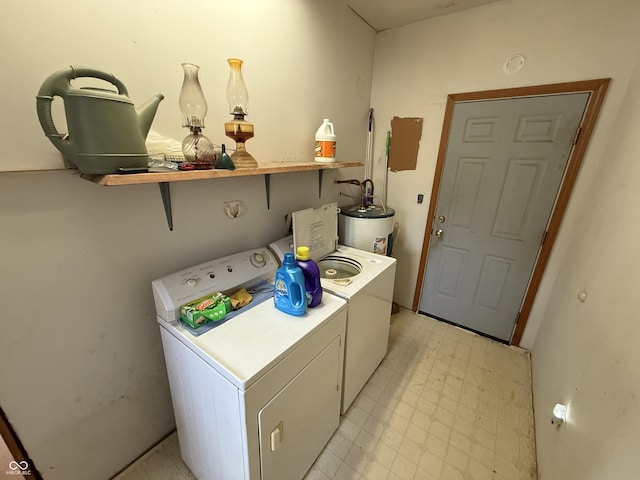 washroom with gas water heater and separate washer and dryer