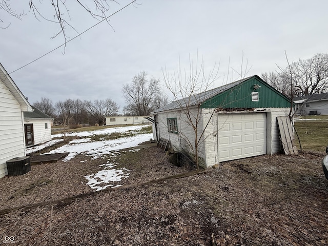 view of side of home featuring an outbuilding and a garage