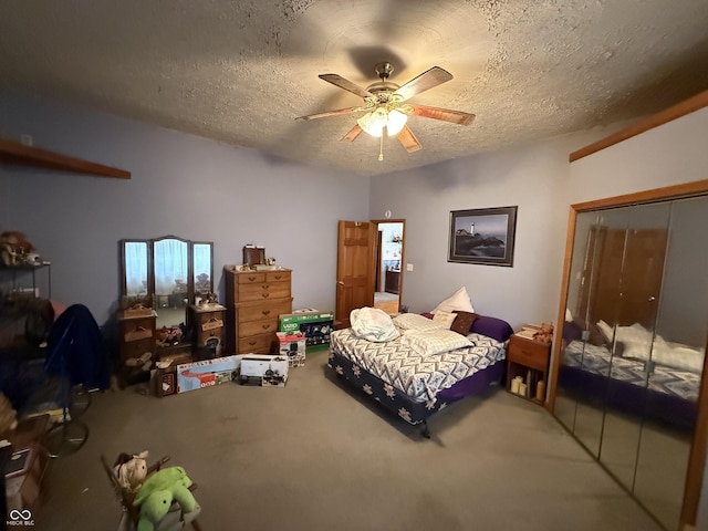 bedroom featuring ceiling fan, a closet, a textured ceiling, and carpet flooring