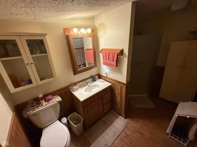 bathroom with vanity, hardwood / wood-style flooring, toilet, and a textured ceiling