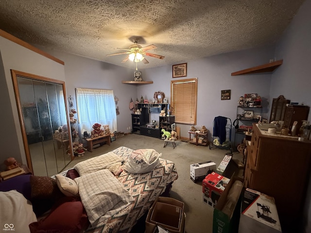 carpeted bedroom featuring ceiling fan, a textured ceiling, and a closet