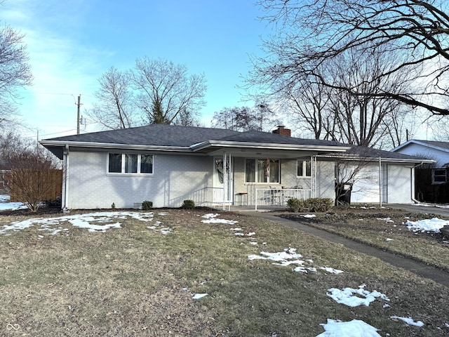 ranch-style house featuring a garage, a porch, and a yard