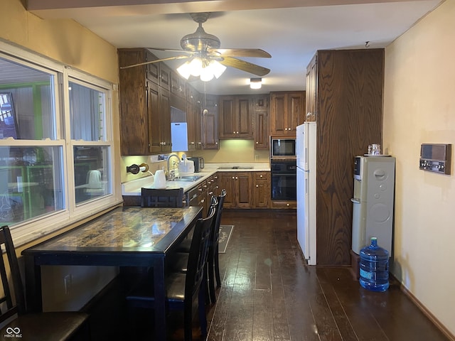 kitchen with sink, dark wood-type flooring, ceiling fan, and black appliances