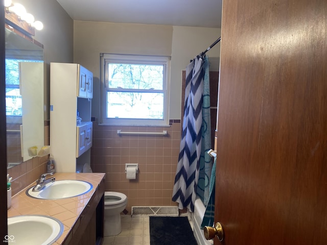 full bathroom with vanity, tile walls, shower / bath combo, and toilet