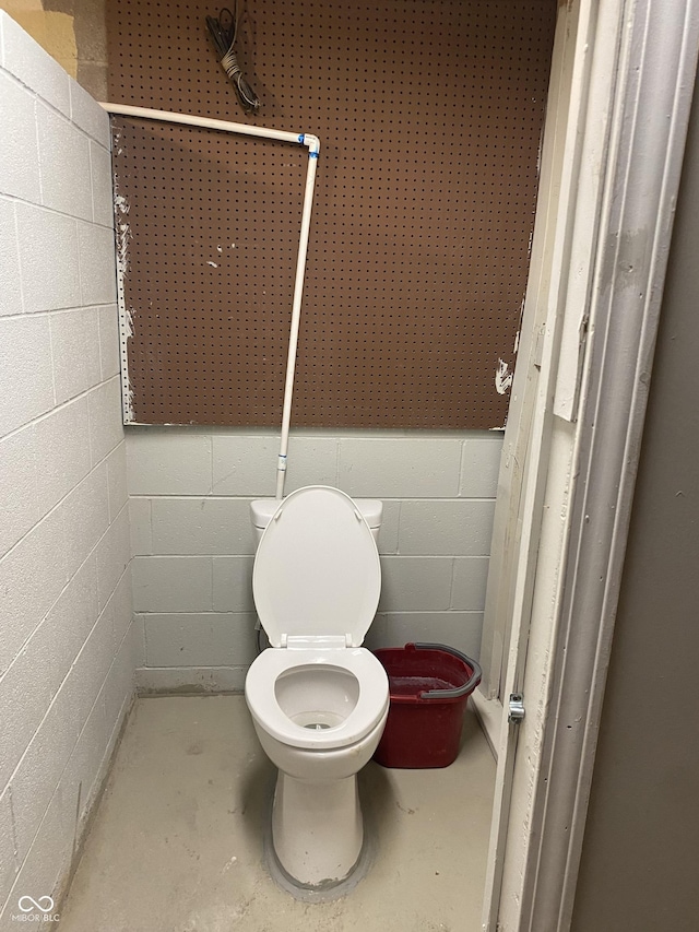 bathroom featuring toilet and concrete flooring