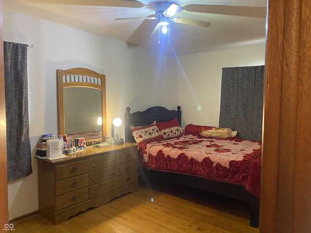 bedroom with ceiling fan and light wood-type flooring