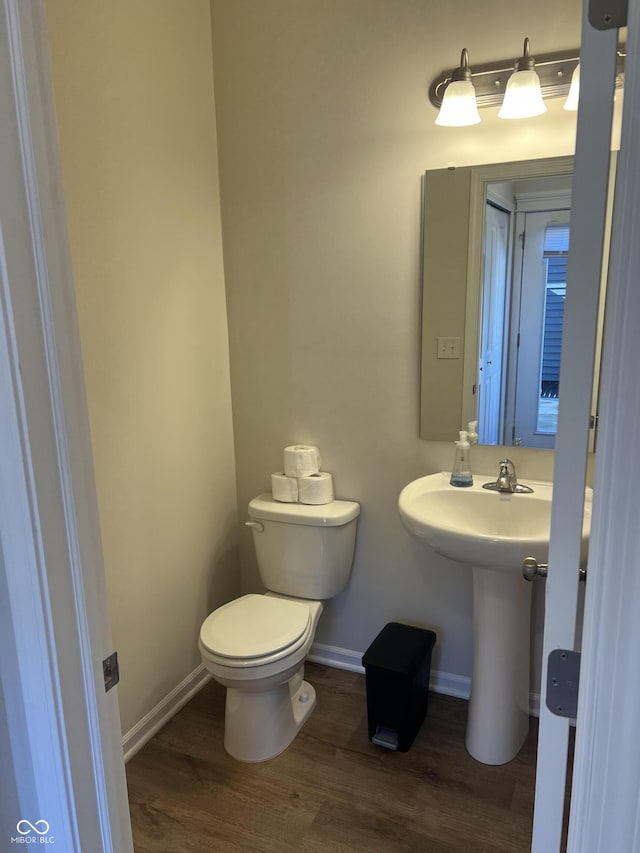 bathroom with wood-type flooring and toilet