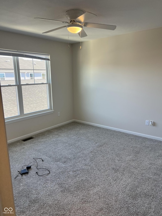 spare room featuring carpet floors and ceiling fan