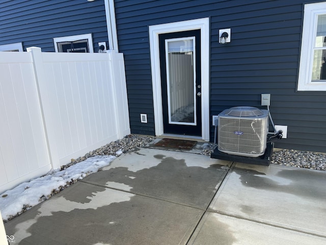 entrance to property featuring a patio area and central air condition unit