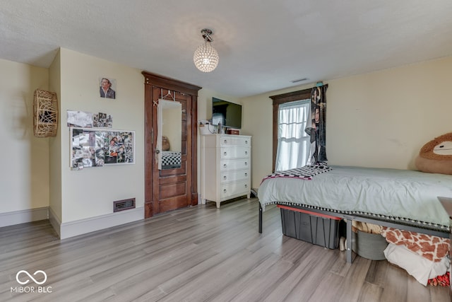 bedroom with light hardwood / wood-style floors