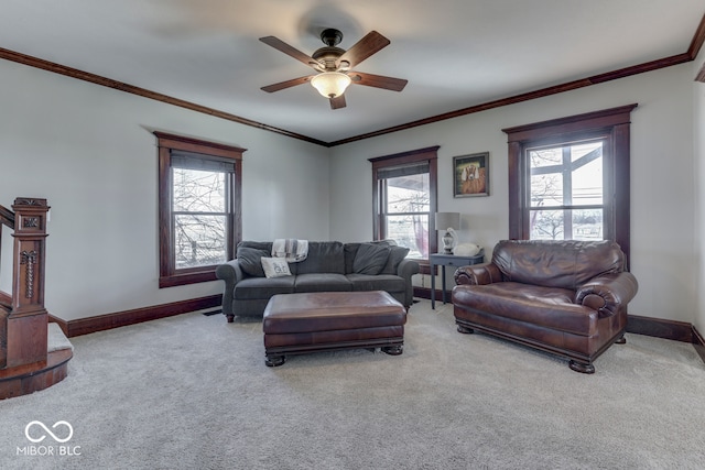 living room featuring crown molding, ceiling fan, and carpet