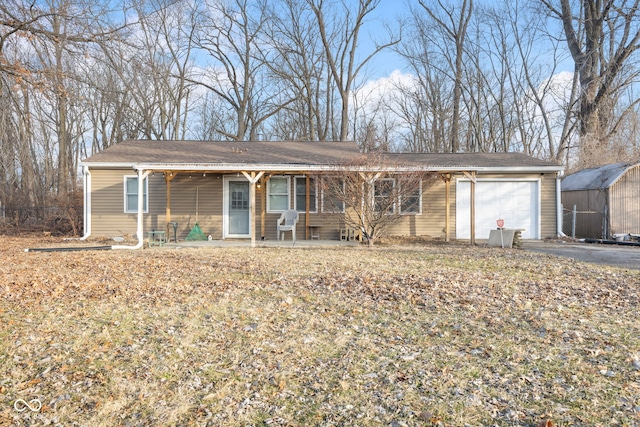 single story home with a garage and covered porch