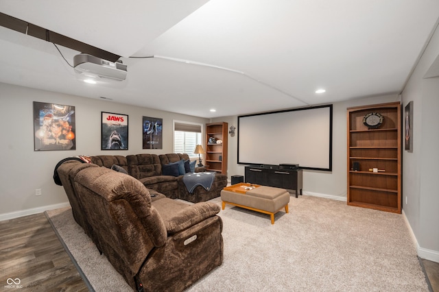 home theater room with hardwood / wood-style flooring and a wall mounted AC