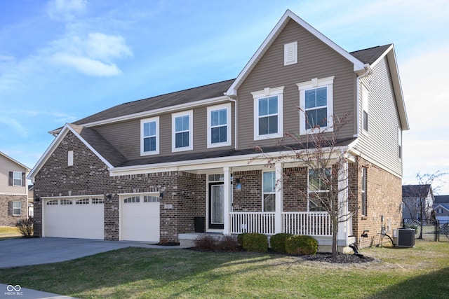 view of front of property featuring a garage, central AC unit, covered porch, and a front yard