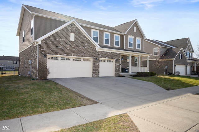 view of front facade with a garage, a front yard, and covered porch