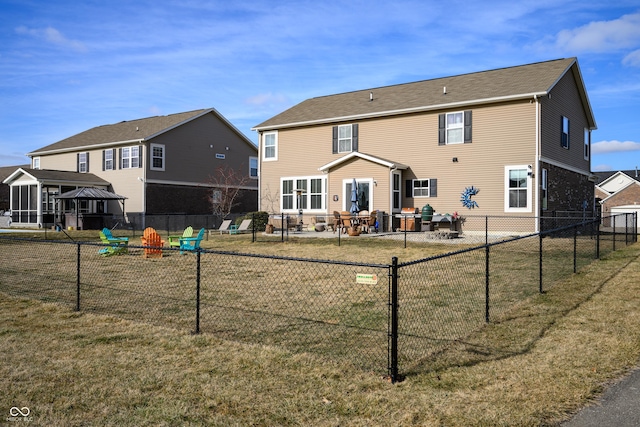 rear view of house featuring a lawn